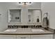 Bathroom featuring double sinks, gray countertops, square mirrors, and a glass shower at 1133 Capital Club Ne Cir, Brookhaven, GA 30319