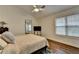 A well-lit bedroom featuring a cozy bed, full-length mirror, and ceiling fan at 1133 Capital Club Ne Cir, Brookhaven, GA 30319