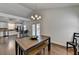 Dining area with wooden table, bench seating, and view to the kitchen with stainless steel appliances at 1133 Capital Club Ne Cir, Brookhaven, GA 30319