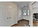 Hallway with gleaming hardwood floors, coat closet, and front door with glass panels at 1133 Capital Club Ne Cir, Brookhaven, GA 30319