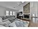 Bright living room with stone fireplace, vaulted ceilings, fan, and hardwood floors at 1133 Capital Club Ne Cir, Brookhaven, GA 30319
