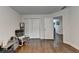 A cozy room featuring hardwood floors, with double closets and a doorway into the next room at 1133 Capital Club Ne Cir, Brookhaven, GA 30319