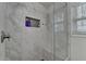 New glass shower with marble tile, a built-in niche, shower head, and a bench at 1133 Capital Club Ne Cir, Brookhaven, GA 30319