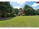 Level backyard with landscaping and mature trees at 5126 Wellsley Bnd, Alpharetta, GA 30005