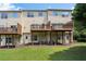 Back of home featuring wooden decks, a well-manicured lawn, and mature trees at 5126 Wellsley Bnd, Alpharetta, GA 30005