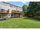Back of the house and spacious backyard with mature trees at 5126 Wellsley Bnd, Alpharetta, GA 30005