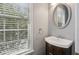 Powder room featuring a wood vanity and dark wood mirror at 5126 Wellsley Bnd, Alpharetta, GA 30005