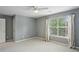 Bedroom showcasing plush carpeting, neutral walls, and a sunlit window at 5126 Wellsley Bnd, Alpharetta, GA 30005