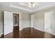 Spacious bedroom with beautiful hardwood floors and doors to a bathroom and walk-in closet at 5126 Wellsley Bnd, Alpharetta, GA 30005