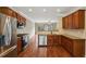 Modern kitchen with stainless steel appliances and hardwood floors at 5126 Wellsley Bnd, Alpharetta, GA 30005