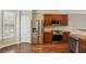 Kitchen area with stainless steel appliances and hardwood floors at 5126 Wellsley Bnd, Alpharetta, GA 30005