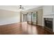 Spacious living room with wood floors, fireplace, and sliding glass doors at 5126 Wellsley Bnd, Alpharetta, GA 30005