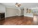 Open-concept living room with hardwood floors and fireplace at 5126 Wellsley Bnd, Alpharetta, GA 30005