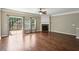 Bright living room with wood floors, fireplace, and patio access at 5126 Wellsley Bnd, Alpharetta, GA 30005