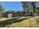 View of the home's large backyard with mature trees and partial fencing at 863 Needle Rock Dr, Stonecrest, GA 30083