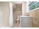 Bathroom with tiled shower, updated vanity and lighting, and neutral finishes at 863 Needle Rock Dr, Stonecrest, GA 30083