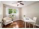Cozy bedroom with hardwood floors, large window, and a work desk at 863 Needle Rock Dr, Stonecrest, GA 30083
