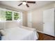 Bedroom with hardwood floors, a ceiling fan, and a bright window at 863 Needle Rock Dr, Stonecrest, GA 30083