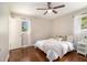 Bedroom with hardwood floors, ceiling fan, and bright windows at 863 Needle Rock Dr, Stonecrest, GA 30083