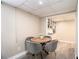 Basement dining area features a round wood table with grey upholstered chairs at 863 Needle Rock Dr, Stonecrest, GA 30083