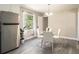 Bright dining area featuring stainless steel refrigerator with a modern table and chairs at 863 Needle Rock Dr, Stonecrest, GA 30083