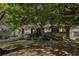 Charming brick home with a landscaped front yard and covered parking at 863 Needle Rock Dr, Stonecrest, GA 30083