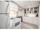 Basement kitchen features white appliances, countertop, and cabinetry at 863 Needle Rock Dr, Stonecrest, GA 30083