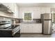 Well-lit kitchen featuring stainless steel appliances, granite counters, and ample storage at 863 Needle Rock Dr, Stonecrest, GA 30083