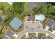 Aerial view of community amenities with a pool, clubhouse, and tennis courts at 306 Coppergate Ct, Holly Springs, GA 30115