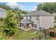 Backyard features a covered patio and playset at 306 Coppergate Ct, Holly Springs, GA 30115