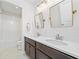 Bathroom with dark wood cabinets, quartz countertops and gold trimmed mirrors at 306 Coppergate Ct, Holly Springs, GA 30115