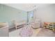 Bright Bedroom with patterned wallpaper, crib, comfortable armchair and whimsical decor at 306 Coppergate Ct, Holly Springs, GA 30115