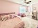 Charming pink bedroom with a plush bed, stuffed animals, and a cozy play area at 306 Coppergate Ct, Holly Springs, GA 30115