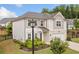 Charming two-story home featuring a landscaped yard, two car garage and inviting front entrance at 306 Coppergate Ct, Holly Springs, GA 30115