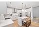 Modern kitchen featuring white cabinets, stainless steel appliances, a center island, and views of the backyard at 306 Coppergate Ct, Holly Springs, GA 30115