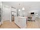 Eat-in kitchen featuring white cabinets, a center island, stainless steel appliances, and a dining area at 306 Coppergate Ct, Holly Springs, GA 30115