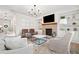 Bright and airy living room with a brick fireplace, built-in shelves and an elegant chandelier at 306 Coppergate Ct, Holly Springs, GA 30115