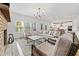 Inviting living room featuring natural light, hardwood floors and a brick fireplace at 306 Coppergate Ct, Holly Springs, GA 30115