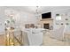 Open-concept living room featuring a brick fireplace, built-in shelves, hardwood floors and an elegant chandelier at 306 Coppergate Ct, Holly Springs, GA 30115