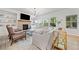 Bright living room featuring a fireplace, built-in shelving, and many windows overlooking the front yard at 306 Coppergate Ct, Holly Springs, GA 30115