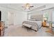 Bright main bedroom showcases a luxurious bed with large windows and neutral decor at 306 Coppergate Ct, Holly Springs, GA 30115