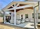 Covered patio featuring outdoor seating, a grill, and a ceiling fan for comfortable outdoor living at 306 Coppergate Ct, Holly Springs, GA 30115