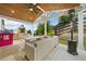 Covered patio with comfortable seating, an outdoor heater, and play area at 306 Coppergate Ct, Holly Springs, GA 30115