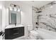 Stylish bathroom with a modern vanity, sleek mirror, and a bathtub shower combination with elegant marble-look tile at 3878 Brookside Pkwy, Decatur, GA 30034