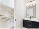 Chic bathroom with black vanity, modern lighting, and a decorative mirror at 3878 Brookside Pkwy, Decatur, GA 30034