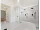 Well-lit primary bathroom with double shower heads in glass shower and sleek white tile at 3878 Brookside Pkwy, Decatur, GA 30034