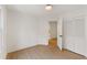 Bedroom featuring wood-look floors, neutral walls, large window and a closet at 3878 Brookside Pkwy, Decatur, GA 30034