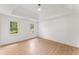 Bright bedroom featuring tray ceilings, wood-look floors, and natural light streaming through two large windows at 3878 Brookside Pkwy, Decatur, GA 30034