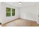 Bedroom with wood-look floors, neutral walls, and natural light from a window at 3878 Brookside Pkwy, Decatur, GA 30034
