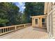 Spacious wooden deck with railing offers a tranquil outdoor living space surrounded by lush trees at 3878 Brookside Pkwy, Decatur, GA 30034
